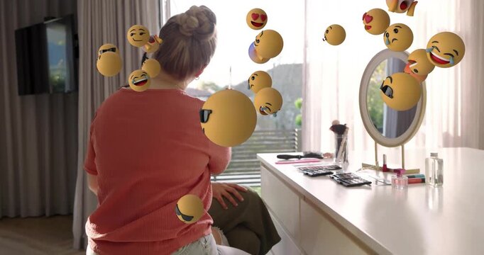 Makeup artist lifting brush blending shadow on eye for beauty demo with emoji spheres drifting