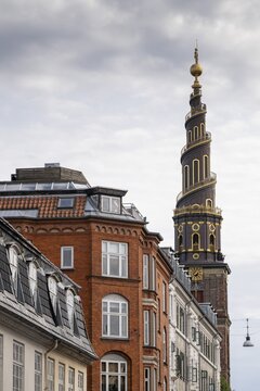 Historic houses, corkscrew-shaped tower of the Evangelical Lutheran Church of the Saviour, in front of Frelsers Kirke, Christianshavn, Copenhagen, Denmark