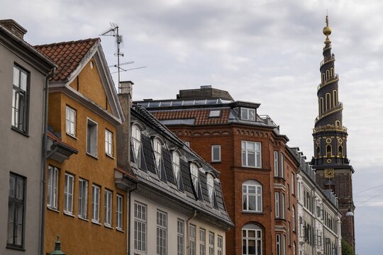 Historic houses, corkscrew-shaped tower of the Evangelical Lutheran Church of the Saviour, in front of Frelsers Kirke, Christianshavn, Copenhagen, Denmark