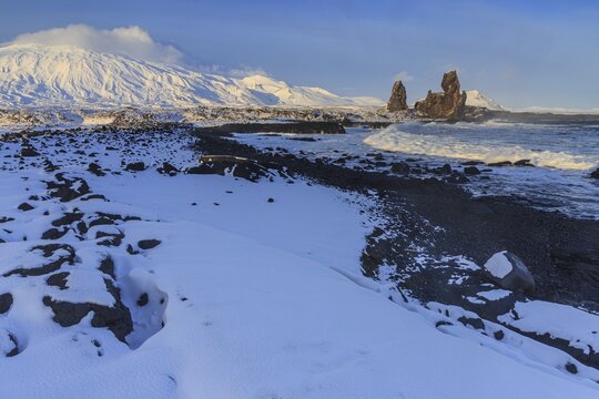Rocks and surf at the coast, evening light, sun, snow, winter, Arnarstapi, Snaefellsj&ouml;kull, Snaefellsnes, Vesturland, Iceland
