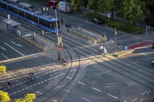 View from above of a road junction with tram and tram stop, cyclists crossing the junction, Stiglmaierplatz, Munich, Upper Bavaria, Bavaria, Germany