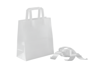 Translucent white polyethylene shopping bag, softly folded, with integrated handles, next to elegantly coiled white satin ribbon, on solid transparent. Product photography concept