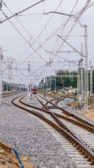 railroad tracks at a train station on a cloudy day