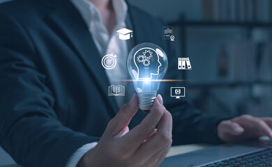 Business holding glowing light bulb with innovation, education, technology icons. Symbol of creative thinking, digital transformation ,knowledge development in modern business and education concepts.
