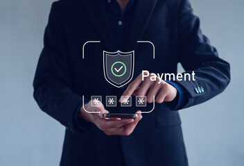 Businessman using smartphone with secure online payment icon. Concept of financial technology, data protection, mobile banking, digital transaction, and cybersecurity in business.