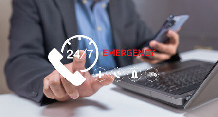 A person in business attire uses a smartphone while interacting with emergency services via a laptop, emphasizing 24 and 7 availability.