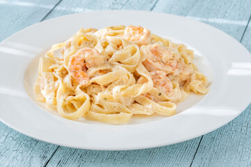 Creamy fettuccine shrimp pasta white plate savory sauce gourmet flavor