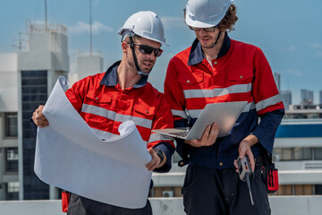 Solar engineer teamwork maintenance energy planning site rooftop project review bright sky, focused...