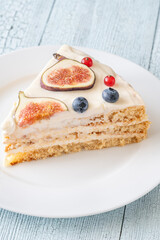 Slice cream cheese berry layer cake figs currant blueberries on plate