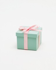 Obraz premium Minimalist Small Pastel Mint Green Gift Box with Pink Satin Ribbon Bow: Clean Studio Shot Isolated on White Background for Elegant E-commerce Mockup