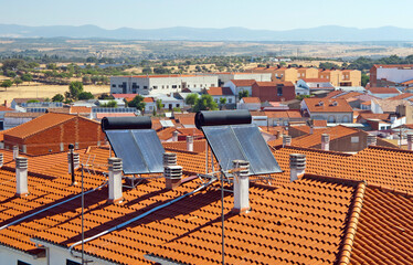 Terracotta Rooftops with Solar Water Heaters in Sunny European Town