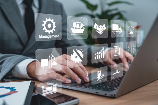 Businessman Managing Corporate Operations and Supply Chain on Laptop with Virtual Management System Icons Interface