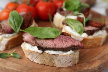 Bruschettas with roast beef served on table, closeup