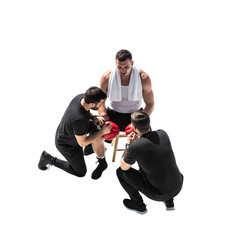 Obraz premium Boxer putting on gloves with trainer and assistant during intense workout session