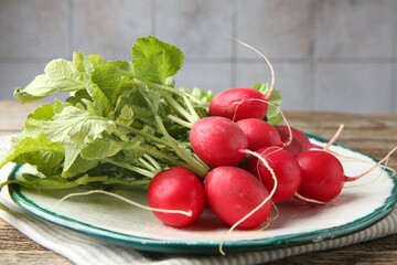 Fresh ripe radishes on wooden table, closeup