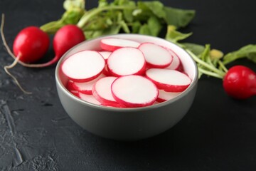 Fresh ripe radishes on grey textured table, closeup