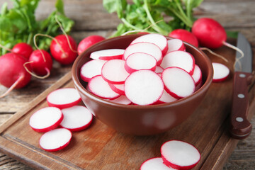Fresh ripe radishes and knife on table, closeup