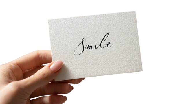 Smile and Hold: A gentle hand delicately holds a card, the word Smile elegantly written. The image invites feelings of positivity, hope, and an optimistic outlook.