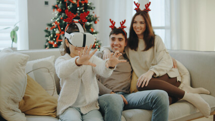 Family enjoys virtual reality experience together in festive living room during the holiday season