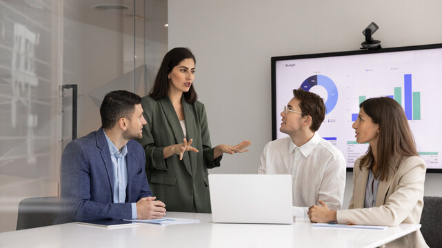 Serious product manager woman presenting growth strategy to team
