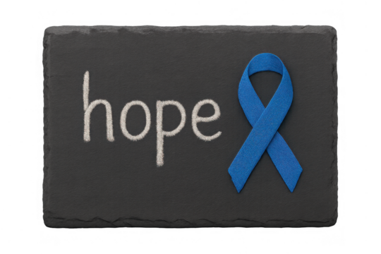 Hope word written in chalk on a dark slate board with a blue awareness ribbon, symbolizing cancer support and prevention