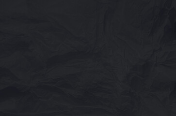 A close-up view of crumpled wrinkled black paper Unique texture and depth creating interesting shadows and highlights. Copy space for your design or text.
