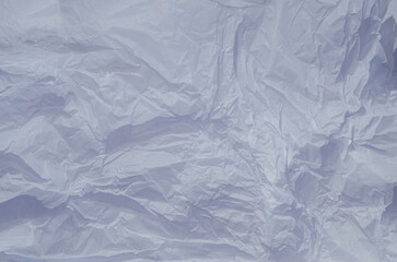 Obraz premium A close-up view of crumpled wrinkled gray paper Unique texture and depth, illuminated by soft, natural light, creating interesting shadows and highlights. Copy space for your design or text