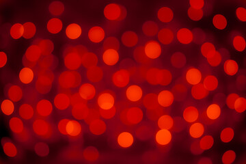 red glowing bokeh circles festive background. blurred, sparkling lights with copy space. abstract banner. christmas design element.