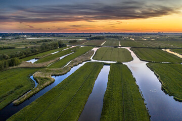 Sunset over canal in Historic dutch landscape