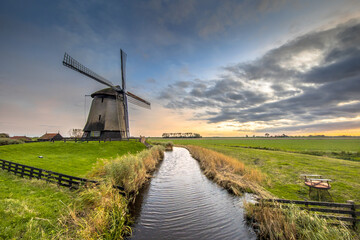 Three Traditional wooden windmills canal