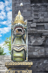 religious stone barong gatekeeper mask sculpture at entrance to Tanah Lot, Bali, Indonesia