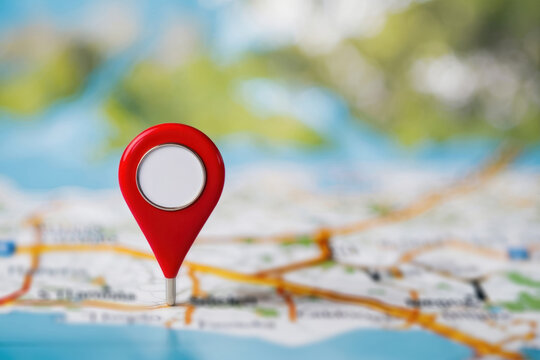 Location revealed. Close up of a map marker with bokeh creating a sense of mystery and exploration.