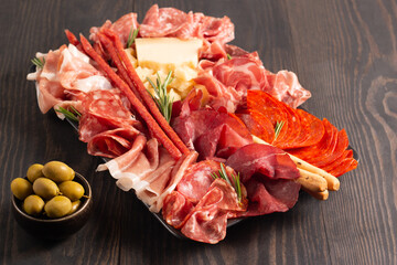 Charcuterie board. Antipasti appetizers of meat platter with salami, prosciutto crudo or jamon and...