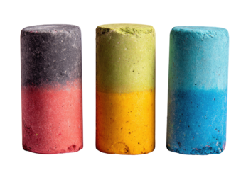 Three cylindrical pieces of colored chalk, displayed vertically, each exhibiting a bi-colored or tri-colored gradient.  
