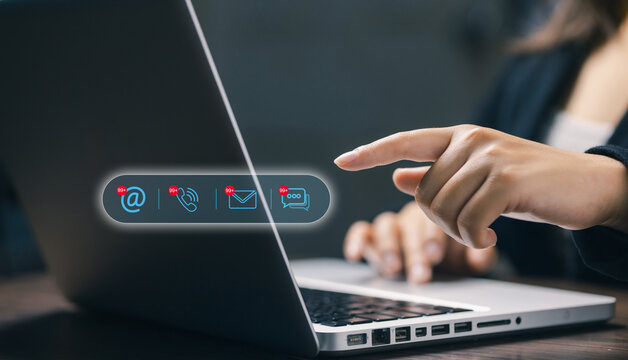 Finger pointing at digital contact icons with email, call, and chat notifications. Concept of online communication, customer support, social media connection, and networking.