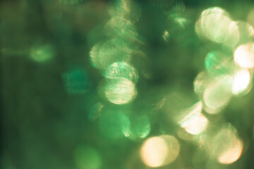 Green and yellow bokeh effect, photo for cover design, festive New Year background image, Christmas decoration