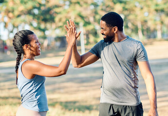 Smiling active young couple jogging exercising and having fun and laughing together taking a break...