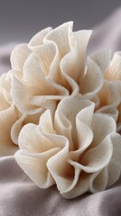 Elegant arrangement of soft beige textured fabric flowers