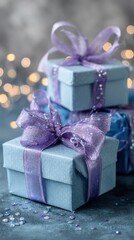 Elegant blue gift boxes with purple ribbons and sparkling decorative accents