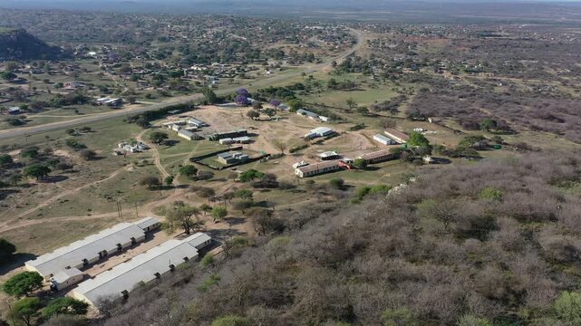 aerial view Serowe hills Botswana, houses and farm, with dirt roads, , bush with acacia trees daytime, rural area