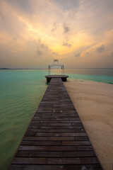 Obraz premium Tranquil closeup calm sea water waves with palm trees. Beautiful Sunset Panorama, Tropical island beach landscape exotic shore coast. Summer vacation, holiday amazing nature. Relax paradise, Maldives.