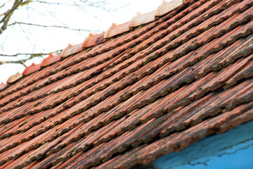 The roof of the house is covered with old red tiles