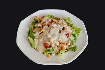 Caesar salad plate on a black tablecloth