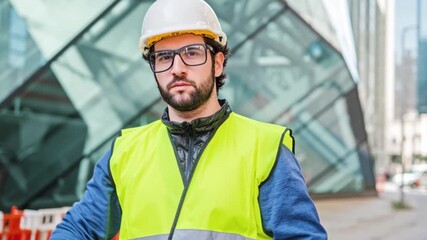 Construction safety officer stopping work with hand gesture, wearing helmet and reflective vest at urban site, workplace safety compliance, risk prevention, industrial protection concept