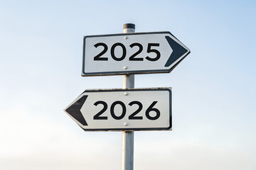 A street signpost pointing to the past (2025) and the future (2026) in opposite directions. A concept of New Year choices and changing times.
 Generative Ai.