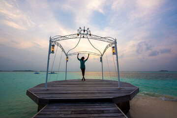 Tranquil closeup calm sea water waves with palm trees. Model on deck. Tropical island beach landscape exotic shore coast. Summer vacation, holiday amazing nature. Relax paradise, Maldives.
