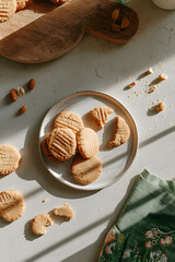 A cozy, relaxed tabletop scene with a plate of homemade shortbread cookies seen from above. cozy home baking, slow living, comfort food, rustic kitchen aesthetics