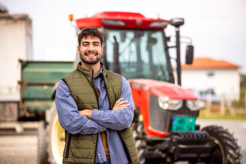 Young tractor driver smiling in front of tractor © Mediteraneo