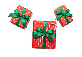 Three festive red gift boxes with green ribbons and a candy cane, isolated on transparent background