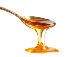 Honey dripping from a spoon.  A golden-amber liquid cascades from a metal spoon,  creating a flowing,  smooth curve